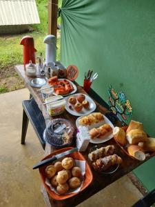 a table with a bunch of food on it at Pousada Sossego do Tocantins in Lajeado