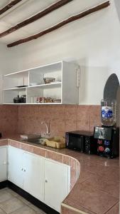 a kitchen with white cabinets and a counter top at 2 Bedroom serene cottage in Ukunda Airport