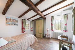 a bedroom with a bed and two windows at Villa au calme jardin piscine proche mer et centre ville in Vallauris +18 photos