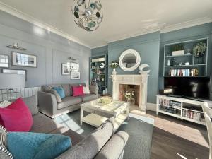 a living room with a couch and a fireplace at The Eastleigh in Seaton