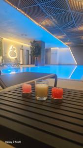 a drink and sushi on a table in a swimming pool at Zemun Golax Apartments in Belgrade