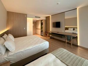 a hotel room with a bed and a desk at Arkk Homes in Antalya