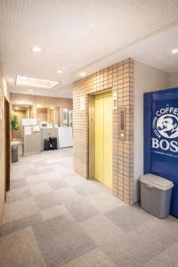 an office lobby with a door and a toilet at 心斎橋難波関空直通Nambaminami direct to Shinsaibashi Ambers Hostel in Osaka