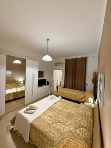 a bedroom with a large bed with two towels on it at Onda blu in Sant'Isidoro