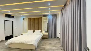a bedroom with a large bed and a window at Villa W2 in Amman +11 photos