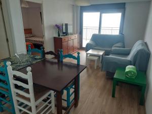 a living room with a table and chairs and a couch at Apartment Núria in Bellreguart +19 photos