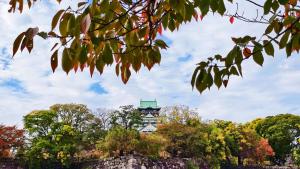 a building with a clock tower in the distance at AYA Residence大阪城公園 Osaka Castle JR Morinomiya 徒歩5min in Osaka