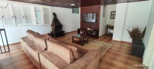 a living room with a couch and a wood stove at Nossa casa in Petrópolis