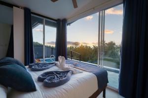 a bedroom with a bed with towels on it at Aura Koh Tao in Ko Tao +89 photos