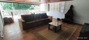 a living room with a couch and a coffee table at Nossa casa in Petrópolis