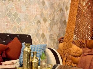 a room with a table with vases on it at Royal Moroccan Escape in Noida in Noida