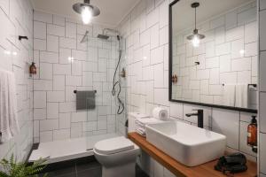 a bathroom with a sink and a toilet and a mirror at The PopCity Hotel in Santiago +26 photos