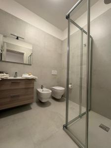 a bathroom with a shower and a toilet and a sink at Borgo San Michele Bed & Breakfast in Calvisano +18 photos
