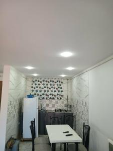 a kitchen with a table and a refrigerator at Appart hôtel palais de mer in Jijel