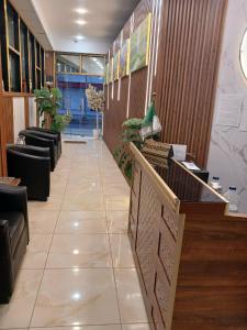 a lobby with chairs and a counter in a building at Appart hôtel palais de mer in Jijel