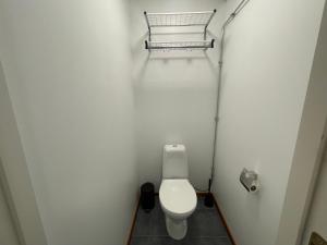 a small bathroom with a toilet in a stall at Laplanders room 3 in Kiruna