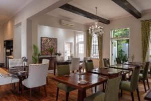 a dining room with a table and chairs at Wild Mushroom Country House in Stellenbosch