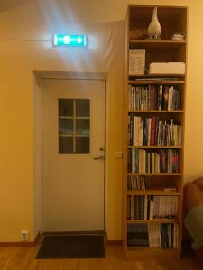 a room with a door and a book shelf with books at Laplanders room 3 in Kiruna