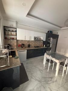 a kitchen with a table and a counter top at Apartment in secure residence in Constantine +7 photos