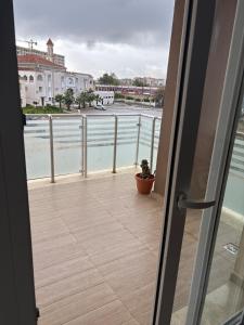 a door to a balcony with a view of the water at Apartment in secure residence in Constantine