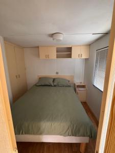 a bedroom with a bed in a small room at Le joli centre energetique in Châteaumeillant