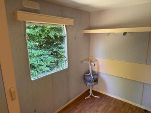 a room with a window and a chair in it at Le joli centre energetique in Châteaumeillant