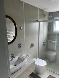 a bathroom with a sink and a toilet and a mirror at Garibaldi Guest House in Garibaldi +26 photos