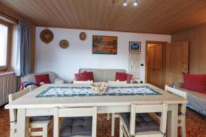 a living room with a table and a couch at Chalet Beppe in Bormio
