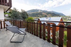 a pair of chairs on the balcony of a house at Chalet Beppe in Bormio +34 photos