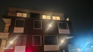 a tall building with windows at night at Zemun Golax Apartments in Belgrade