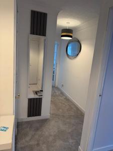 a hallway with a mirror on the wall at Nessy5 Apartment in Inverness +37 photos
