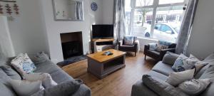 a living room with two couches and a television at Seashells in Bridlington