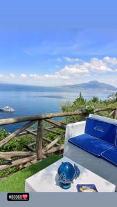 a blue hat sitting on a table with a view of the ocean at La Palombara B&B in Vico Equense