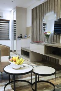 a kitchen with a bowl of fruit on a table at Sri Suryas Hotel in Colombo