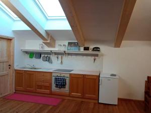 a kitchen with wooden cabinets and a skylight at Openspace in legno La Casa sull'Albero in Osimo