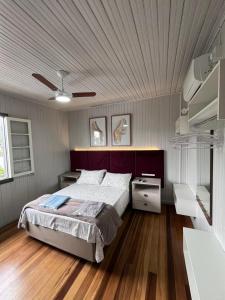 a bedroom with a large bed and a wooden floor at Garibaldi Guest House in Garibaldi