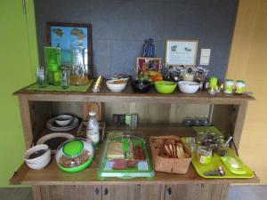 a wooden shelf with bowls and other items on it at B&B Wiezebed in Wieze