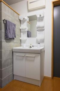 a bathroom with a white sink and a mirror at Aso Vista in Aso +58 photos