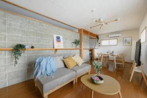 a living room with a couch and a table at Aso Vista in Aso