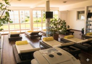 a living room with a bunch of couches and tables at Hotel Hebelhof in Bad Bellingen
