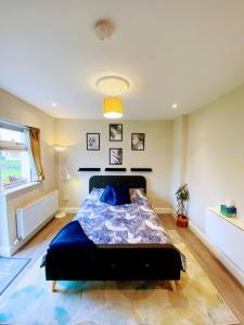 a bedroom with a bed with a blue comforter at Private en-suite studio in Dunboyne