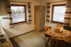 a small kitchen with a table and a window at Lü de Terza in San Vigilio Di Marebbe