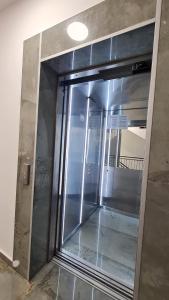 a glass door in a building with a light on it at La Vista Apartment in Petrovac na Moru