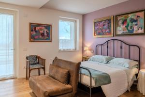 a bedroom with a bed and a chair at GIULIVETO Bed and Breakfast in Foligno +32 photos