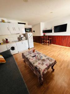 a living room with a table in front of a kitchen at Neptuno 12 in Caleta De Fuste