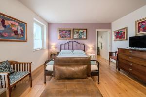 a bedroom with a bed and a tv and a couch at GIULIVETO Bed and Breakfast in Foligno