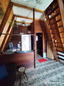 a room with a desk in a house with wooden ceilings at Chalés Caraguatatuba in Caraguatatuba