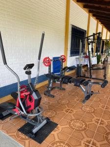 a gym with several treadmills and cardio machines at Fascinação Café Hotel in Cunha