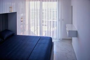 a bedroom with a bed and a large window at Flat in Shëngjin Beachfront Getaway in Shëngjin +12 photos