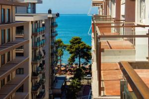 an aerial view of the ocean between buildings at Flat in Shëngjin Beachfront Getaway in Shëngjin